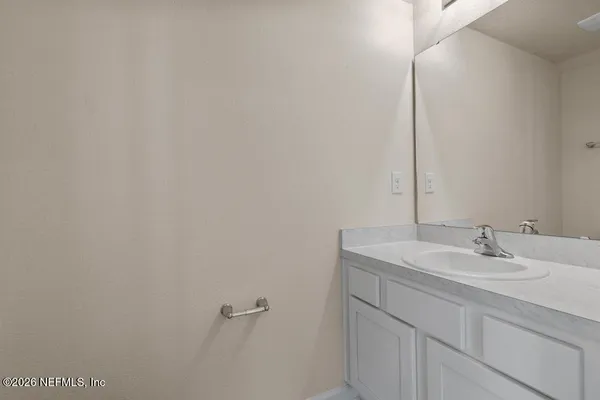 a bathroom with a sink and vanity