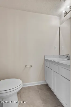 a bathroom with a sink a toilet and mirror