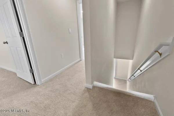 a view of a hallway with staircase