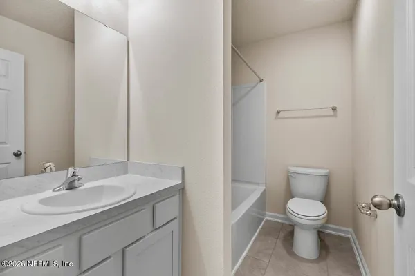 a bathroom with a bathtub sink vanity and toilet