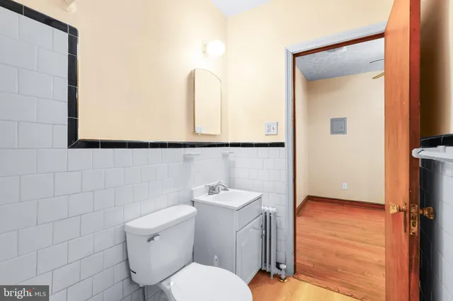 a bathroom with a toilet a sink and mirror