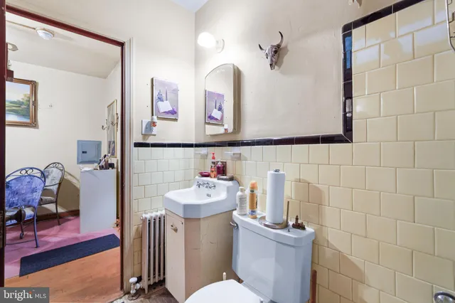 a bathroom with a sink mirror and toilet