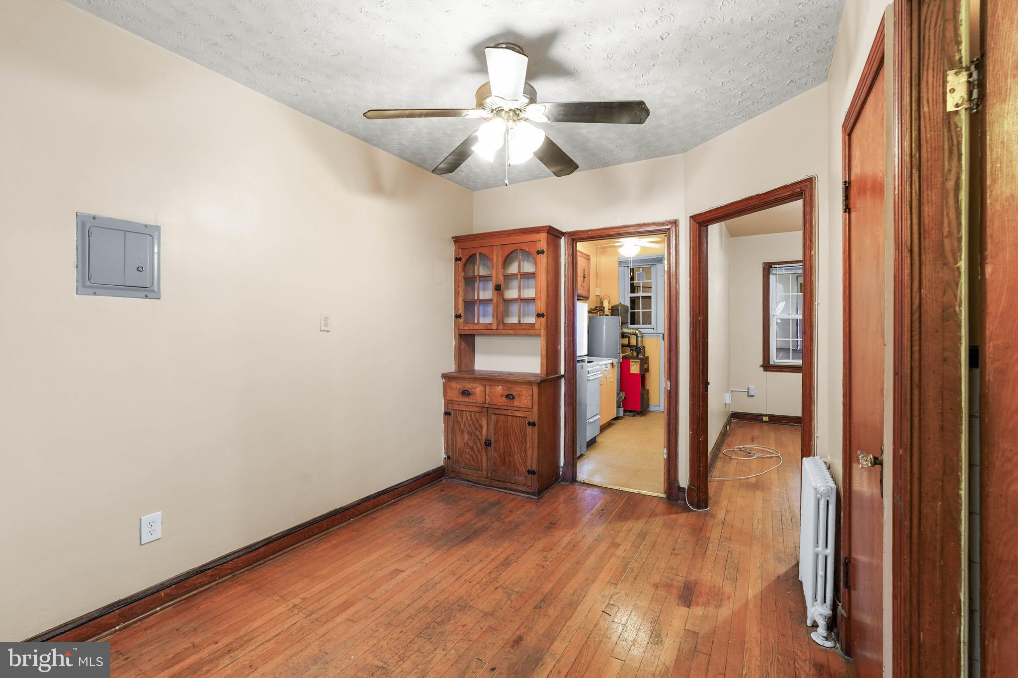 1515 17th Street Southeast Washington, DC 20020 - Photo 7 of 16 an empty room with wooden floor and chandelier