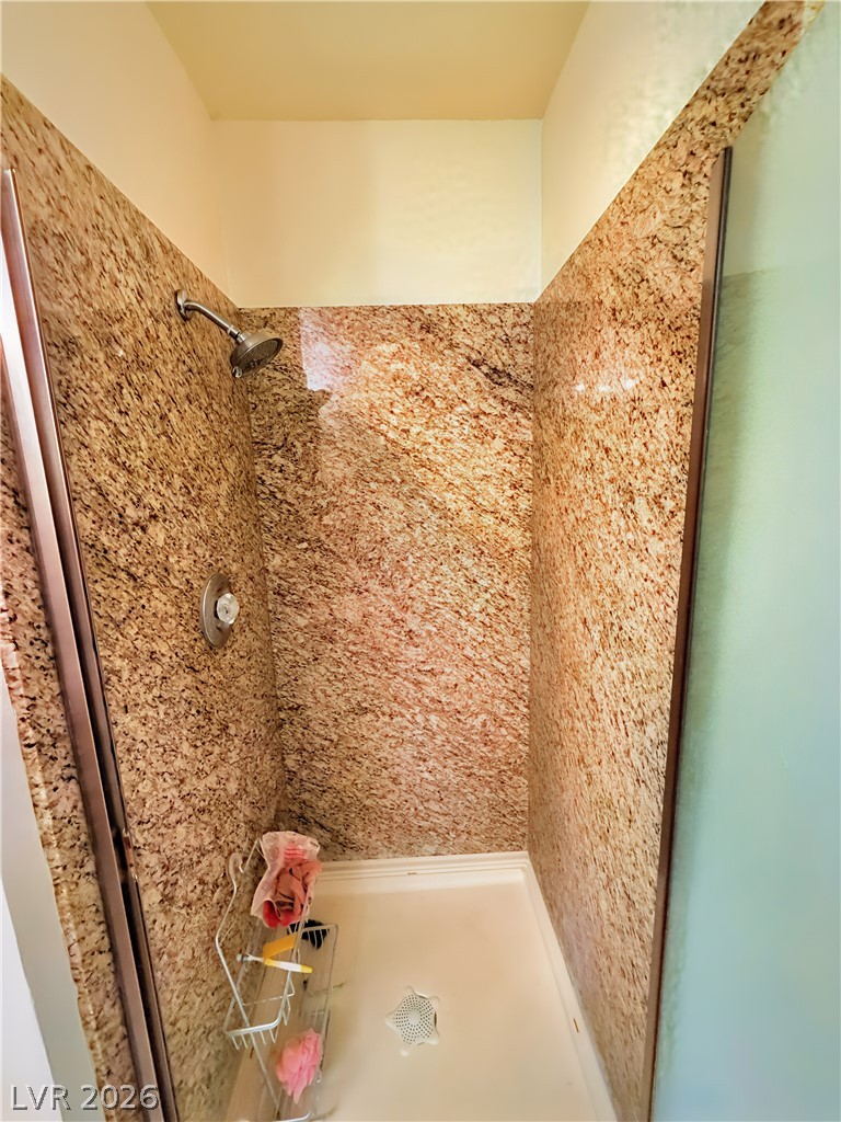 1852 North Decatur Boulevard, Unit 101 Las Vegas, NV 89108 - Photo 33 of 45 Polished granite surrounds define this walk-in shower enclosure.