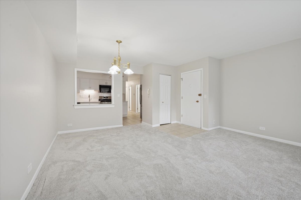 7320 Lake Street, Unit 1A River Forest, IL 60305 - Photo 11 of 22 an empty room with a fireplace and chandelier