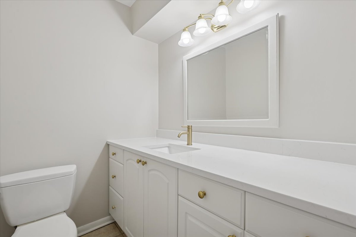 7320 Lake Street, Unit 1A River Forest, IL 60305 - Photo 15 of 22 a bathroom with a sink vanity granite toilet and a mirror