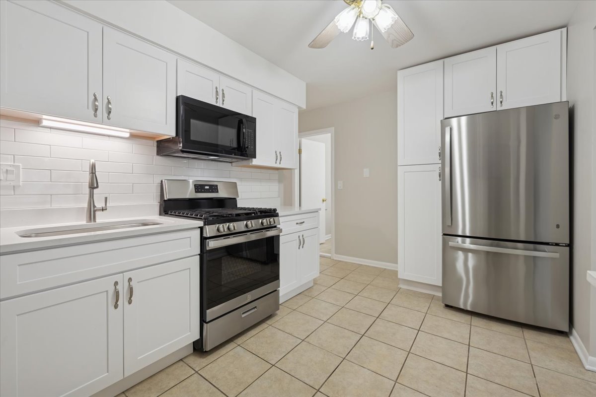 7320 Lake Street, Unit 1A River Forest, IL 60305 - Photo 7 of 22 a kitchen with cabinets stainless steel appliances and a sink