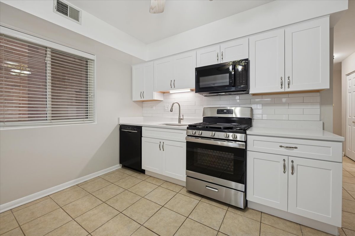 7320 Lake Street, Unit 1A River Forest, IL 60305 - Photo 8 of 22 a kitchen with stainless steel appliances a stove a microwave and a sink