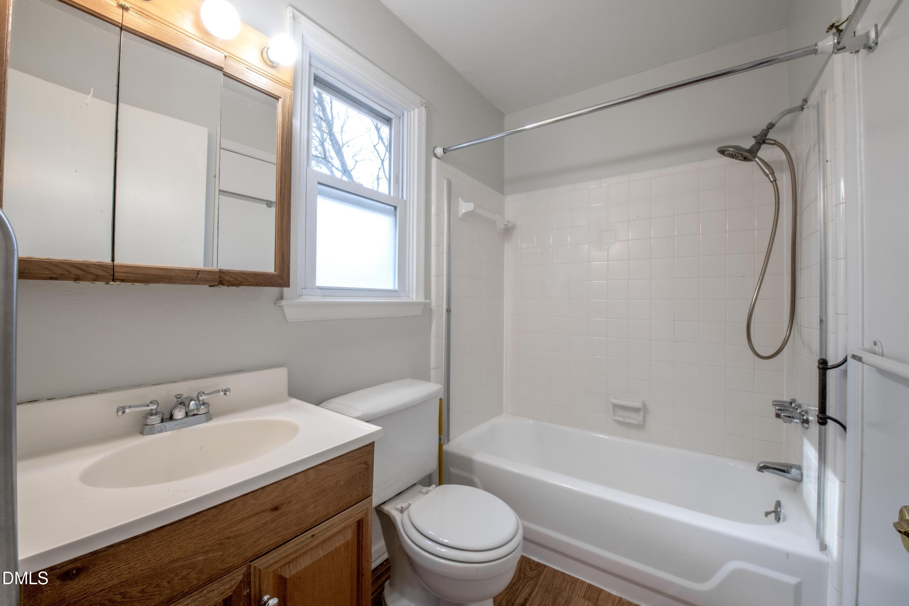 116 East Judd Street Zebulon, NC 27597 - Photo 13 of 21 a bathroom with a sink toilet and shower