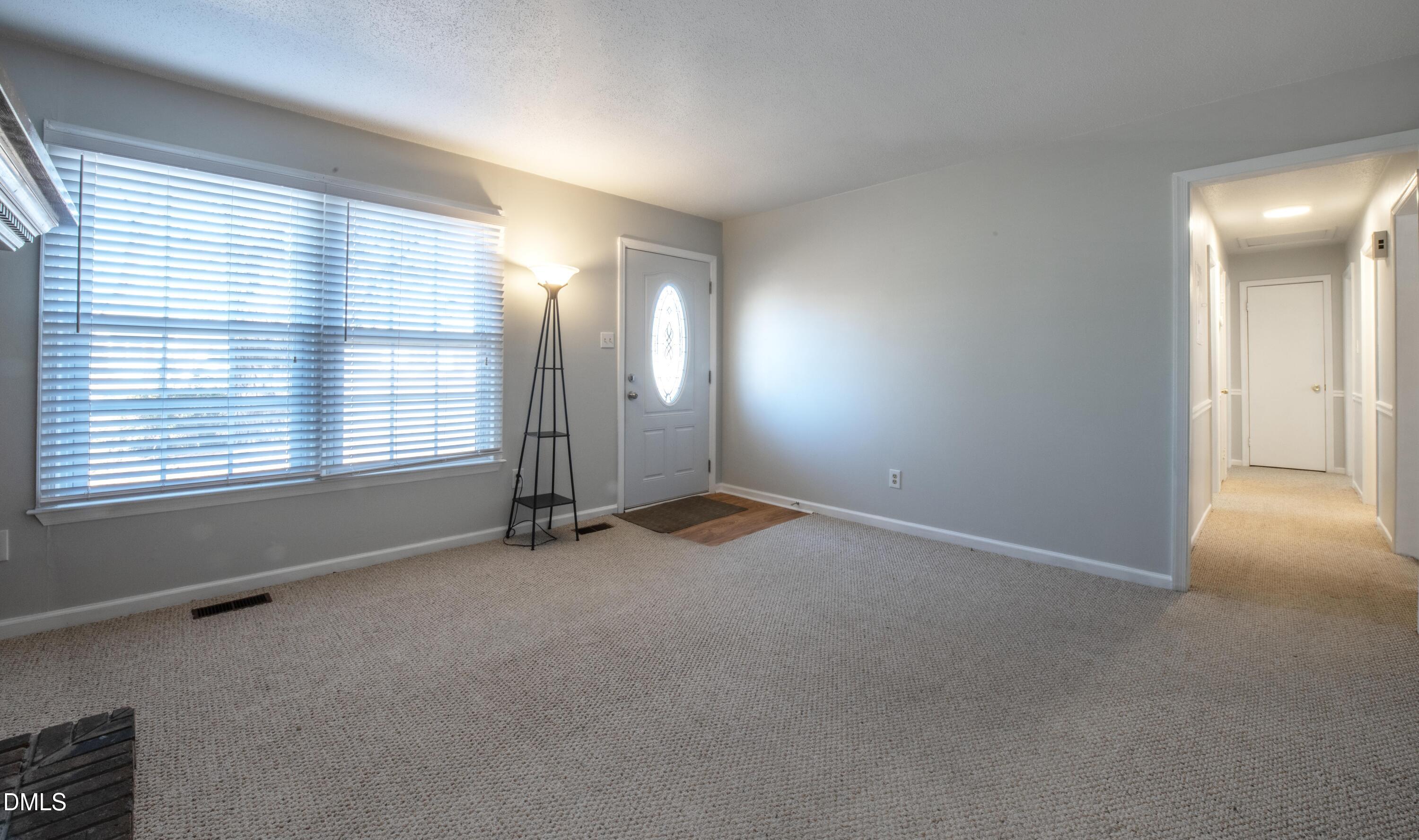 116 East Judd Street Zebulon, NC 27597 - Photo 3 of 21 an empty room with windows