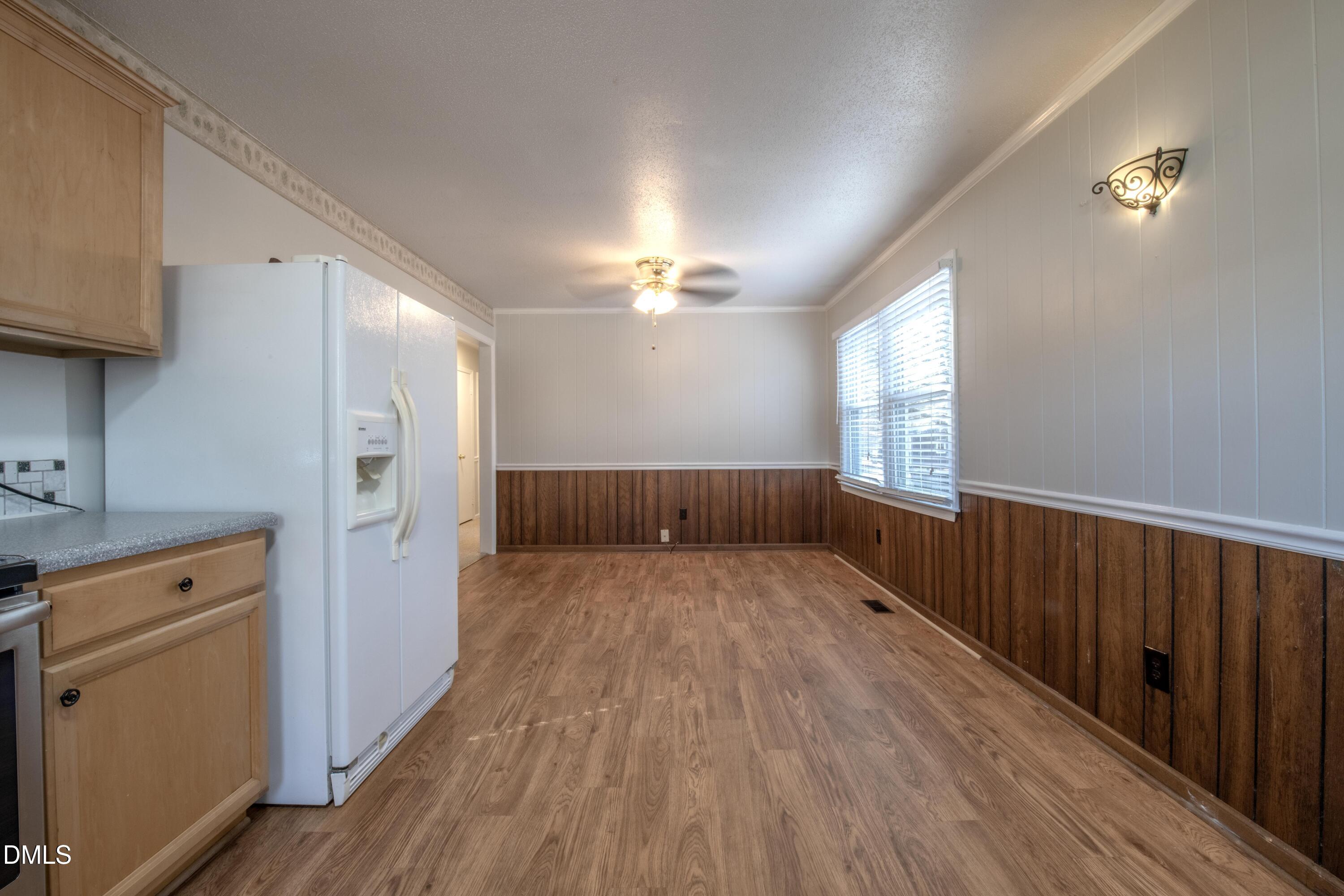 116 East Judd Street Zebulon, NC 27597 - Photo 8 of 21 a view of a kitchen with a sink a refrigerator and wooden floor