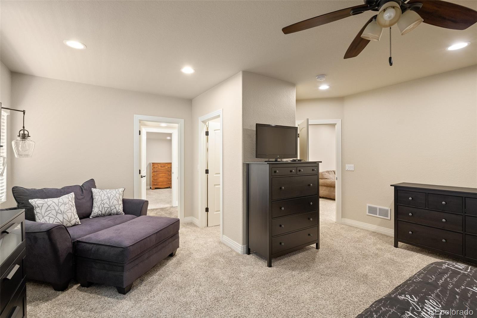 41865 East Muirfield Loop Elizabeth, CO 80107 - Photo 33 of 50 a living room with furniture and a flat screen tv