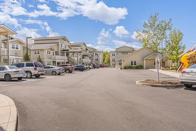 a view of road with card and parked cars