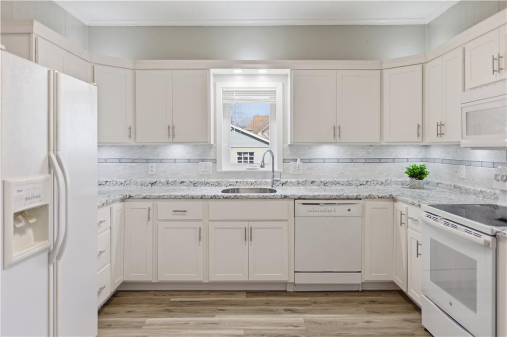 715 5th Street New Brighton, PA 15066 - Photo 11 of 30 a kitchen with granite countertop white cabinets white appliances and sink