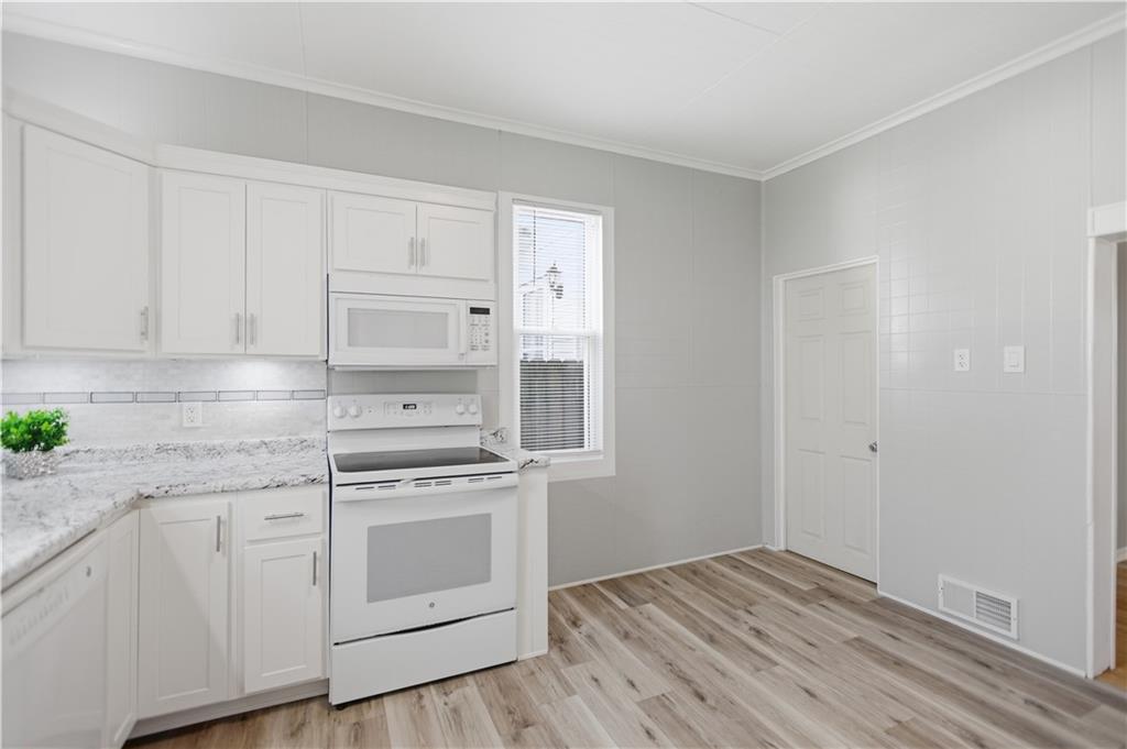 715 5th Street New Brighton, PA 15066 - Photo 14 of 30 a kitchen with white cabinets and white appliances