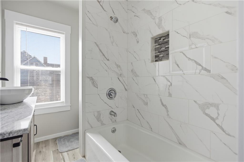 715 5th Street New Brighton, PA 15066 - Photo 21 of 30 a bathroom with a granite countertop sink and a bathtub
