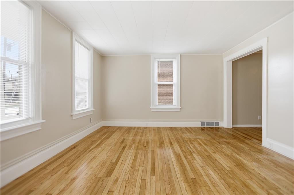 715 5th Street New Brighton, PA 15066 - Photo 5 of 30 a view of an empty room with wooden floor and a window