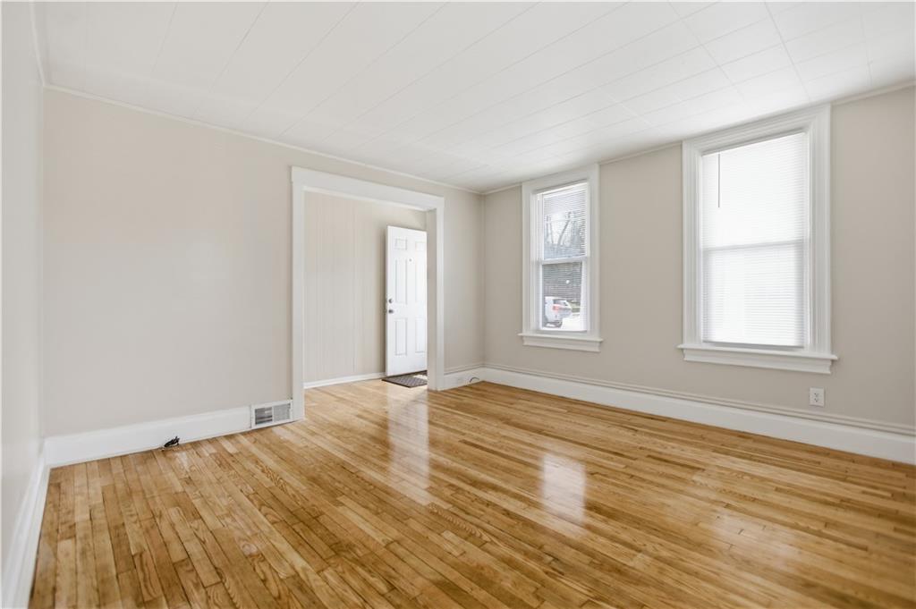 715 5th Street New Brighton, PA 15066 - Photo 7 of 30 a view of empty room with wooden floor and fan