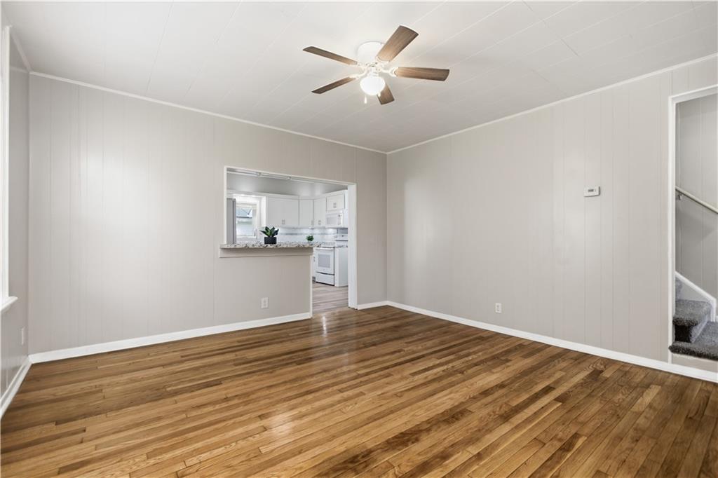 715 5th Street New Brighton, PA 15066 - Photo 8 of 30 an empty room with wooden floor and a ceiling fan