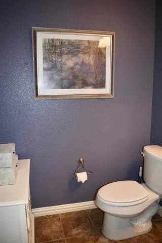 a white toilet sitting next to a bathroom sink