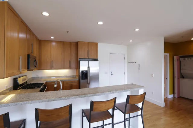 a large kitchen with a table and chairs