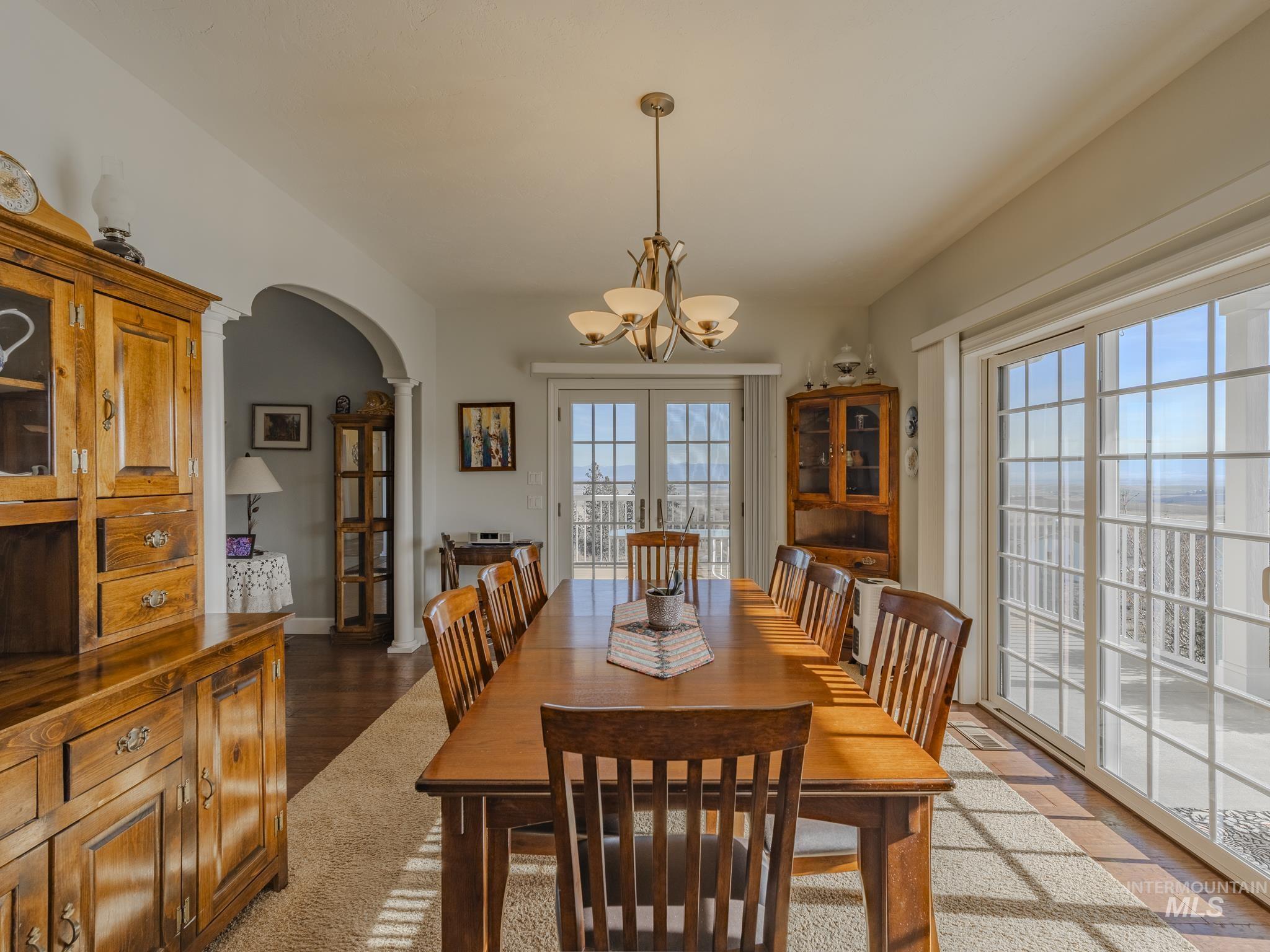 659 Reservation Line Road Cottonwood, ID 83522 - Photo 22 of 50 Dining room featuring arched walkways and hanging lights