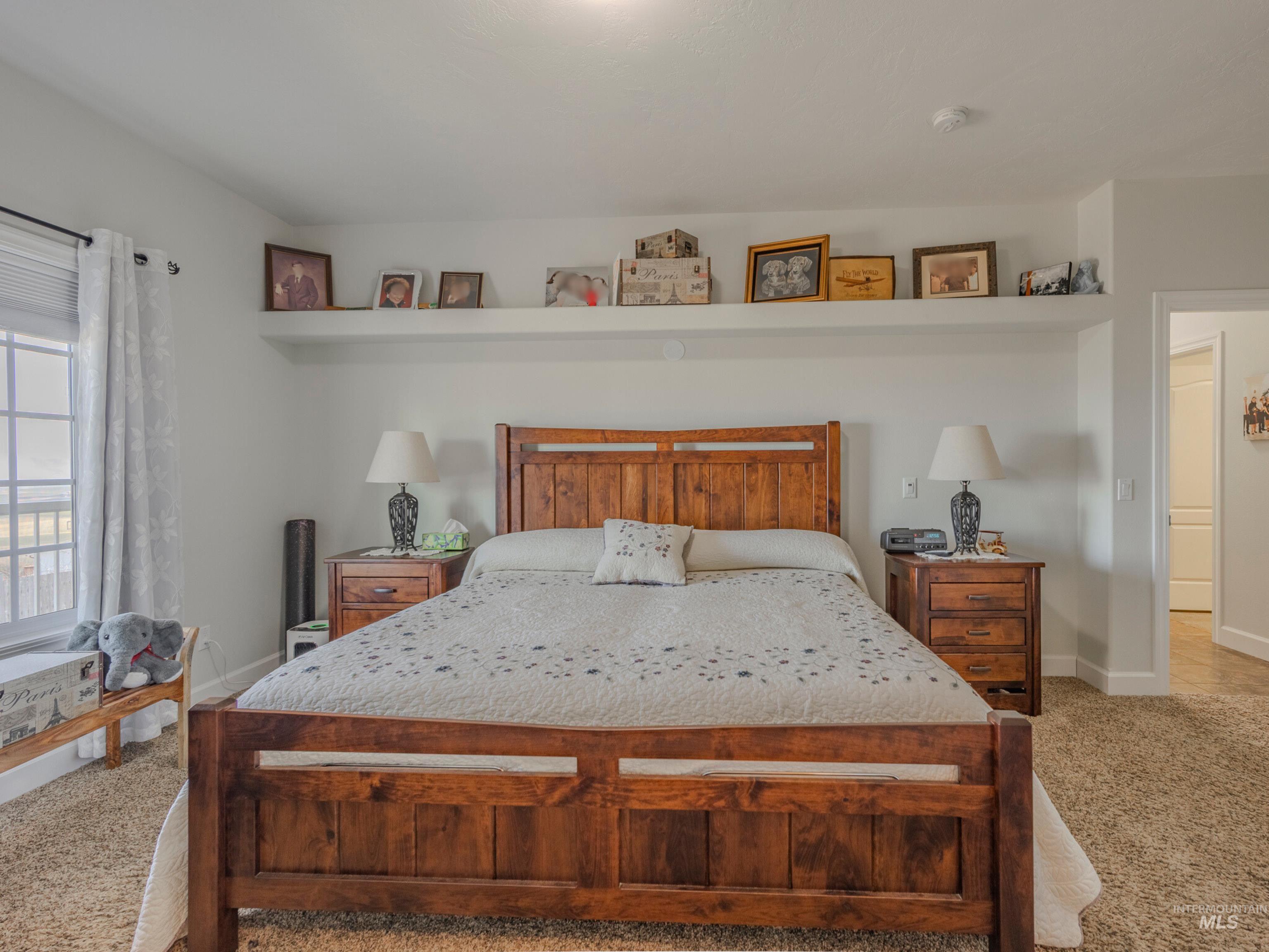 659 Reservation Line Road Cottonwood, ID 83522 - Photo 25 of 50 Bedroom with light colored carpet and baseboards