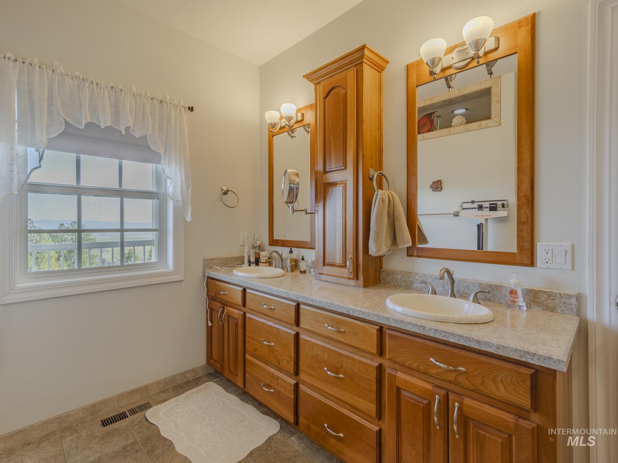 659 Reservation Line Road Cottonwood, ID 83522 - Photo 27 of 50 Full bathroom featuring double vanity and dark tile patterned flooring