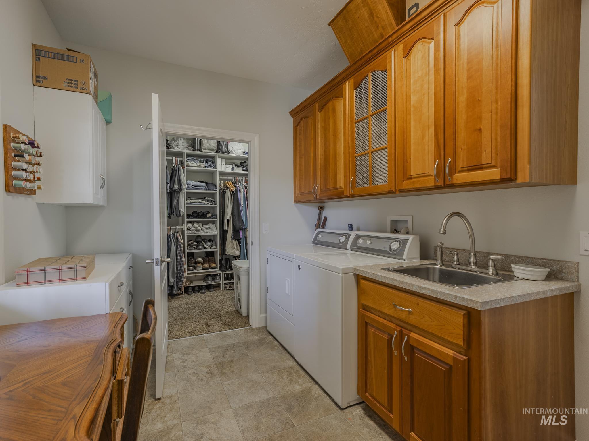 659 Reservation Line Road Cottonwood, ID 83522 - Photo 31 of 50 Laundry room with cabinet space and washer and dryer