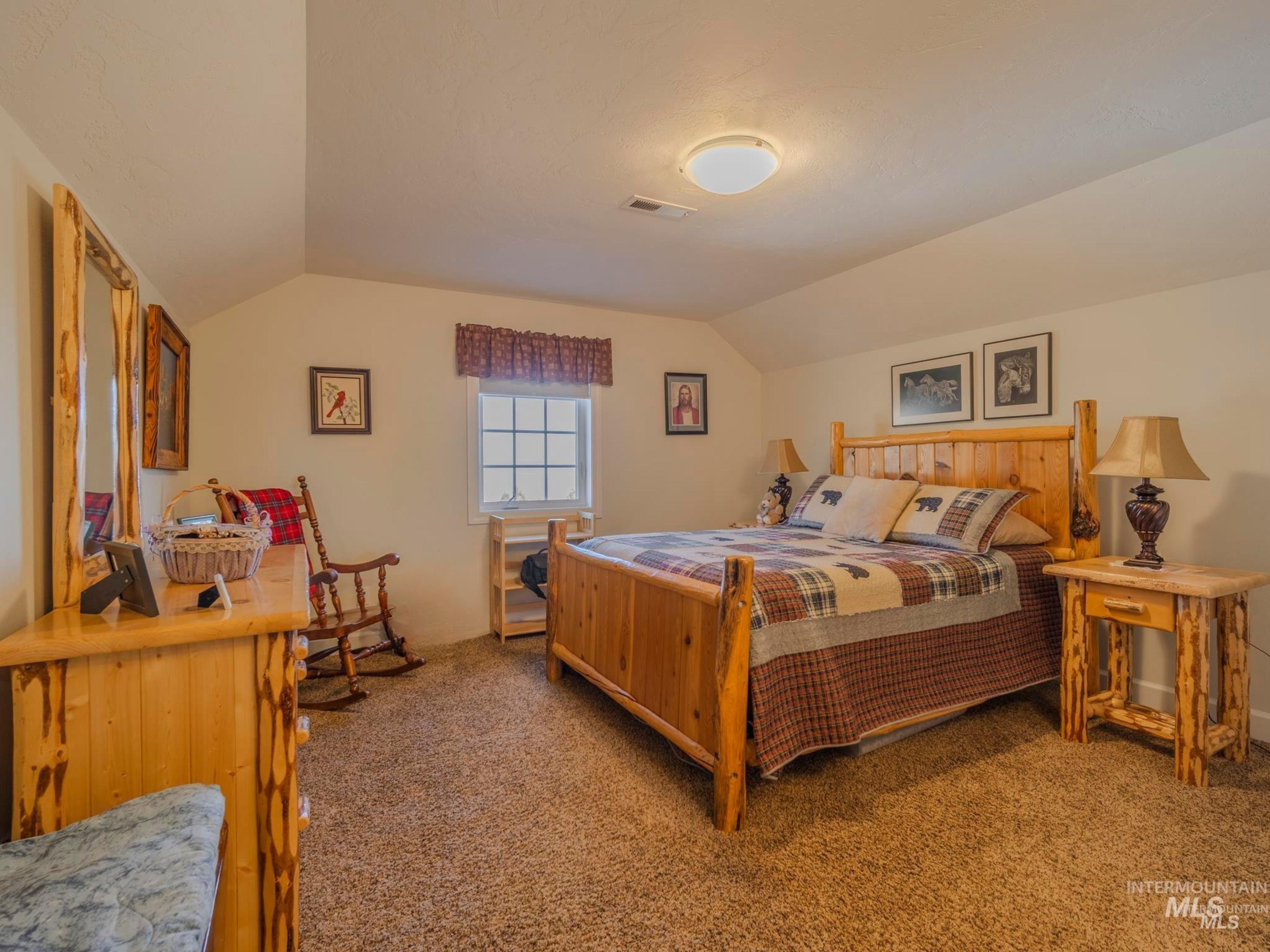 659 Reservation Line Road Cottonwood, ID 83522 - Photo 41 of 50 Carpeted bedroom with vaulted ceiling