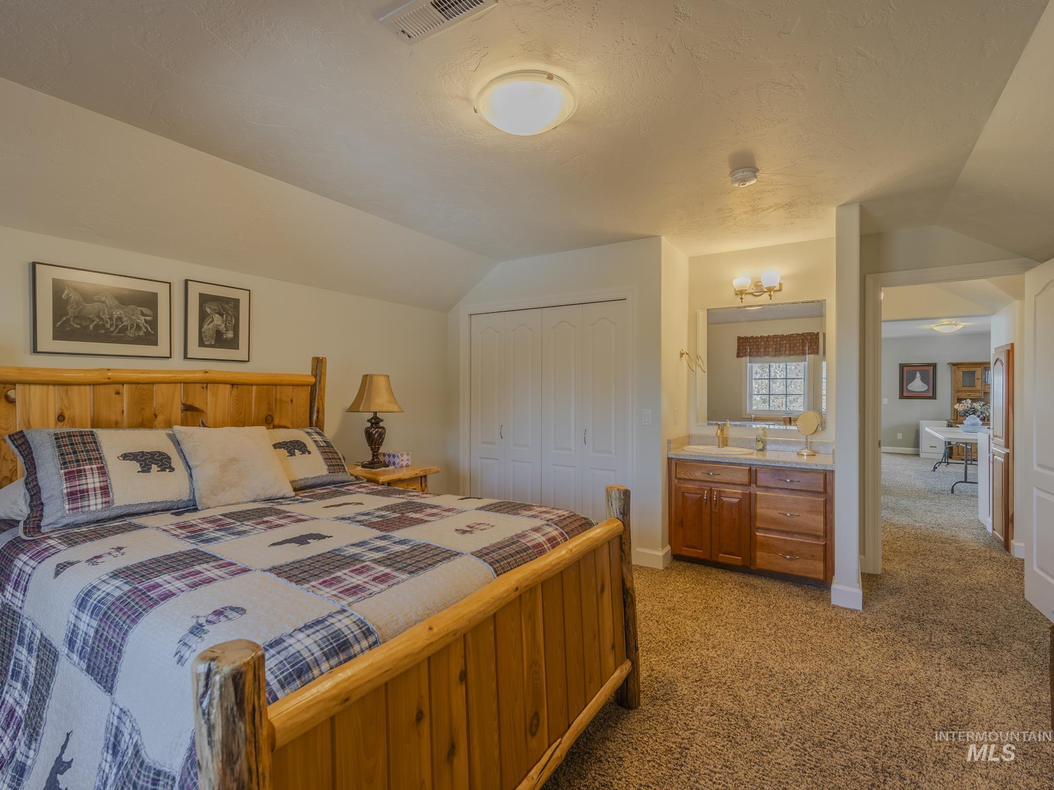 659 Reservation Line Road Cottonwood, ID 83522 - Photo 42 of 50 Bedroom with light colored carpet and a closet