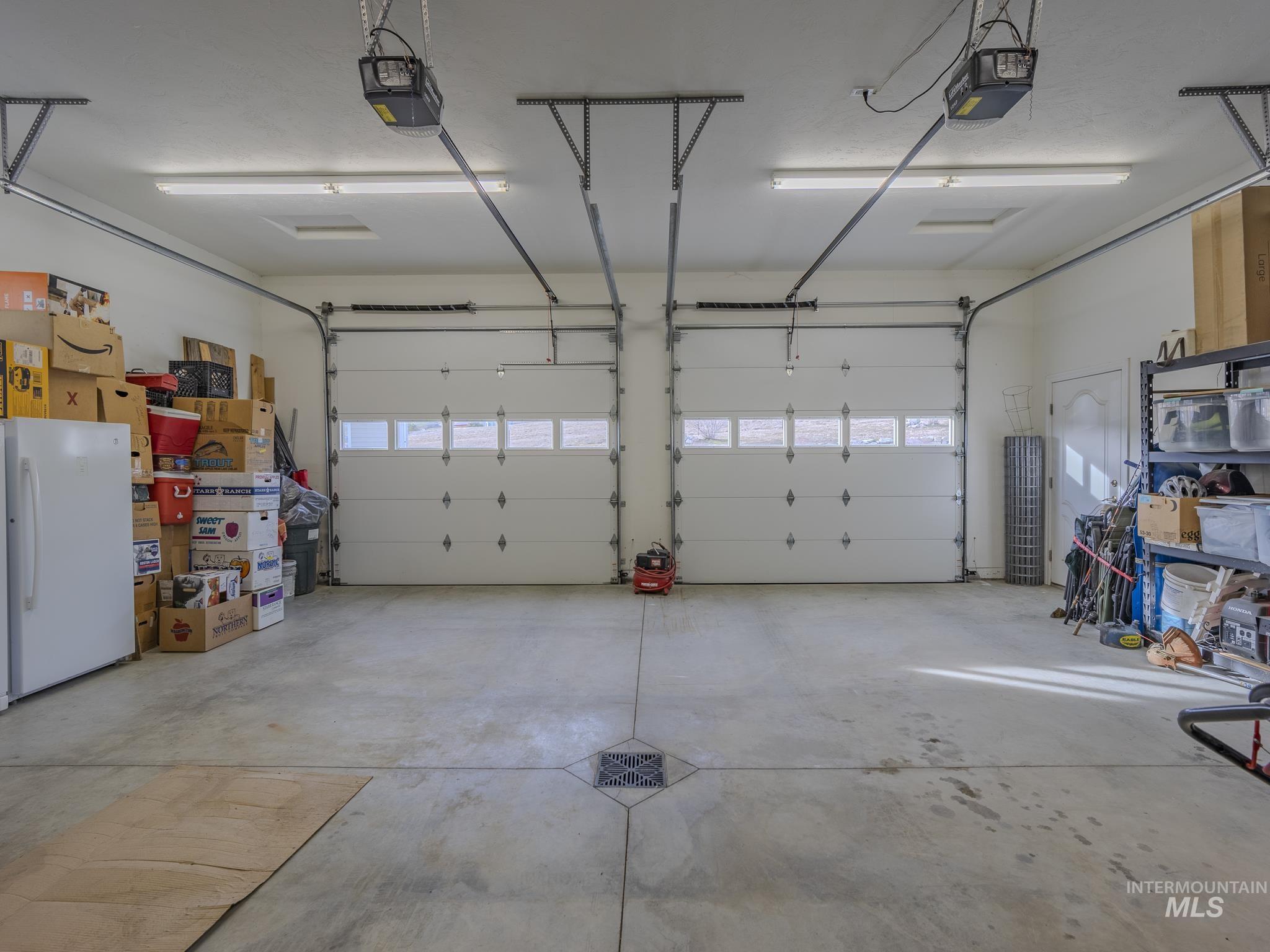 659 Reservation Line Road Cottonwood, ID 83522 - Photo 47 of 50 Garage featuring freestanding refrigerator and a garage door opener