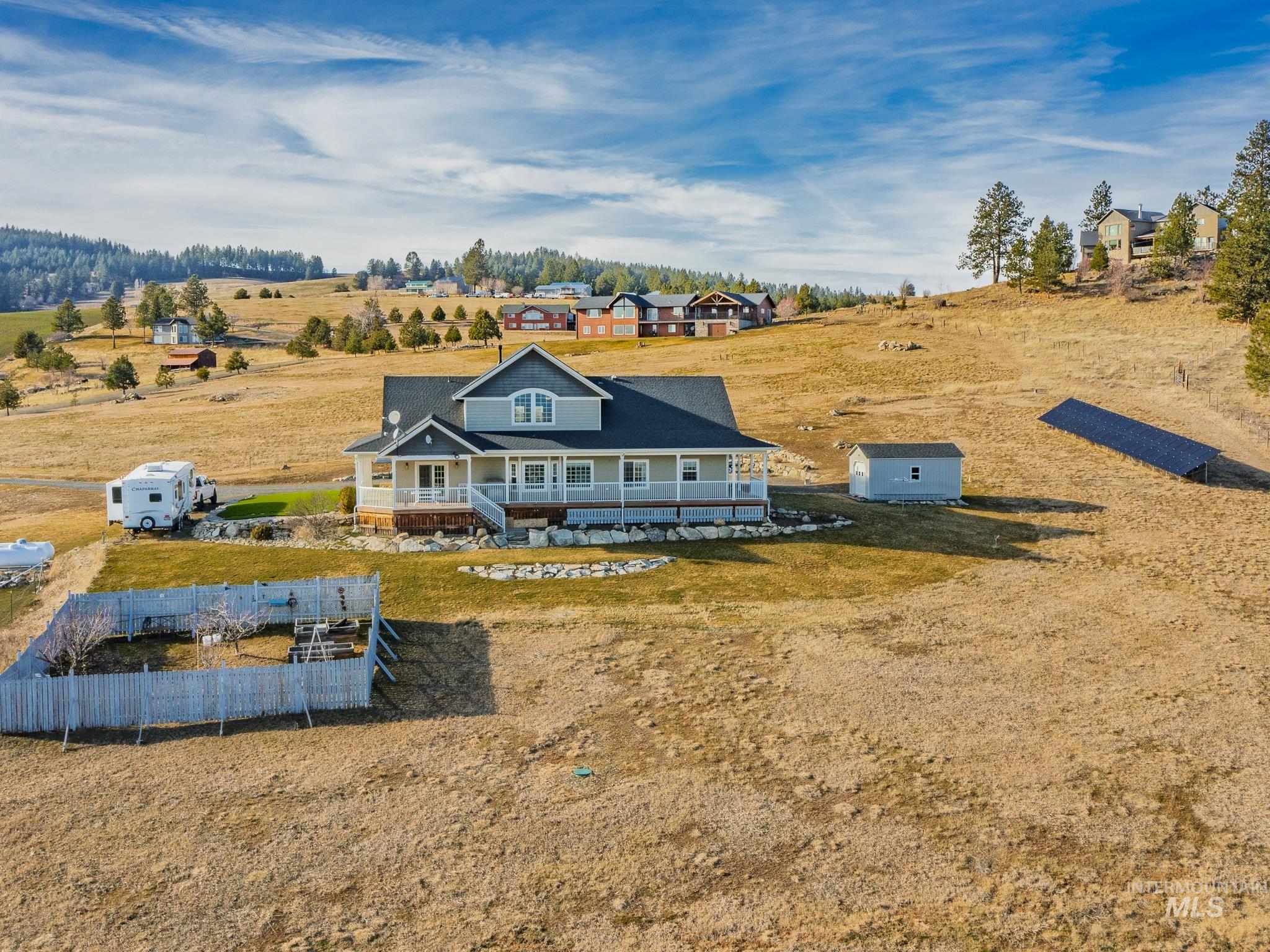 659 Reservation Line Road Cottonwood, ID 83522 - Photo 49 of 50 Back of property with covered porch, a view of countryside, and an outdoor structure