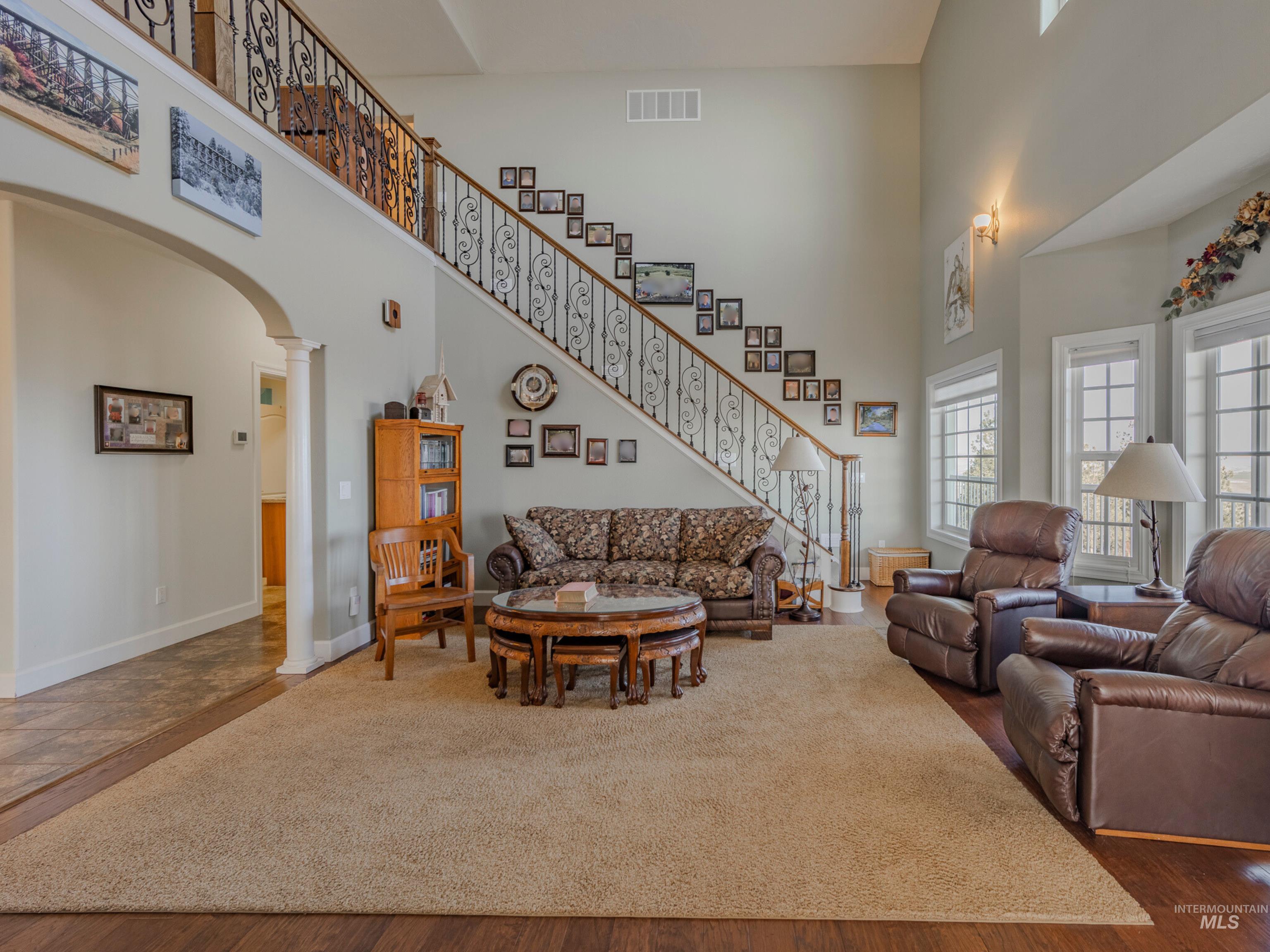 659 Reservation Line Road Cottonwood, ID 83522 - Photo 9 of 50 Living room featuring a high ceiling and arched walkways