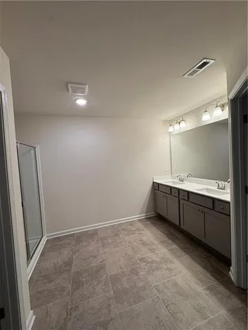 a view of an empty room with cabinet and a window
