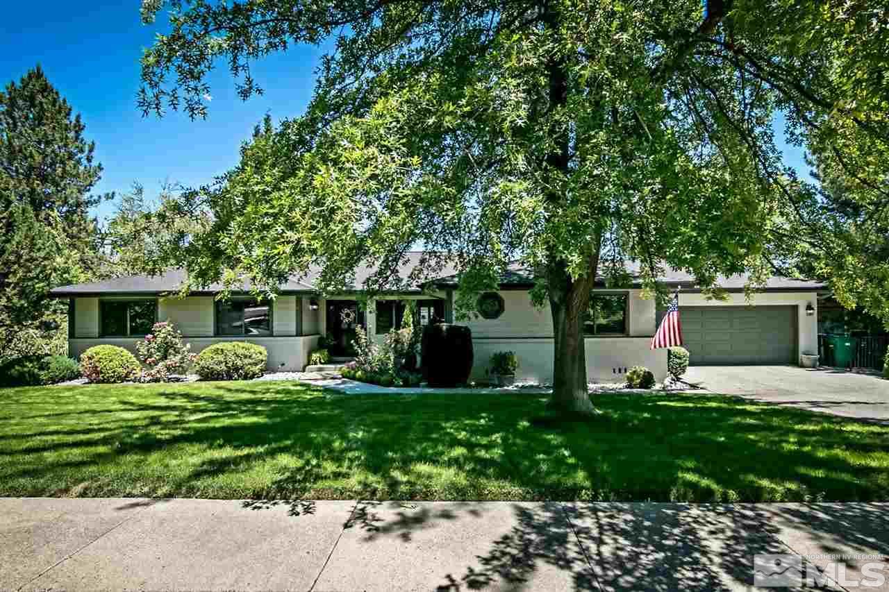 2275 Pennswood Way Reno, NV 89509 - Photo 1 of 33 a front view of house with yard and trees in the background
