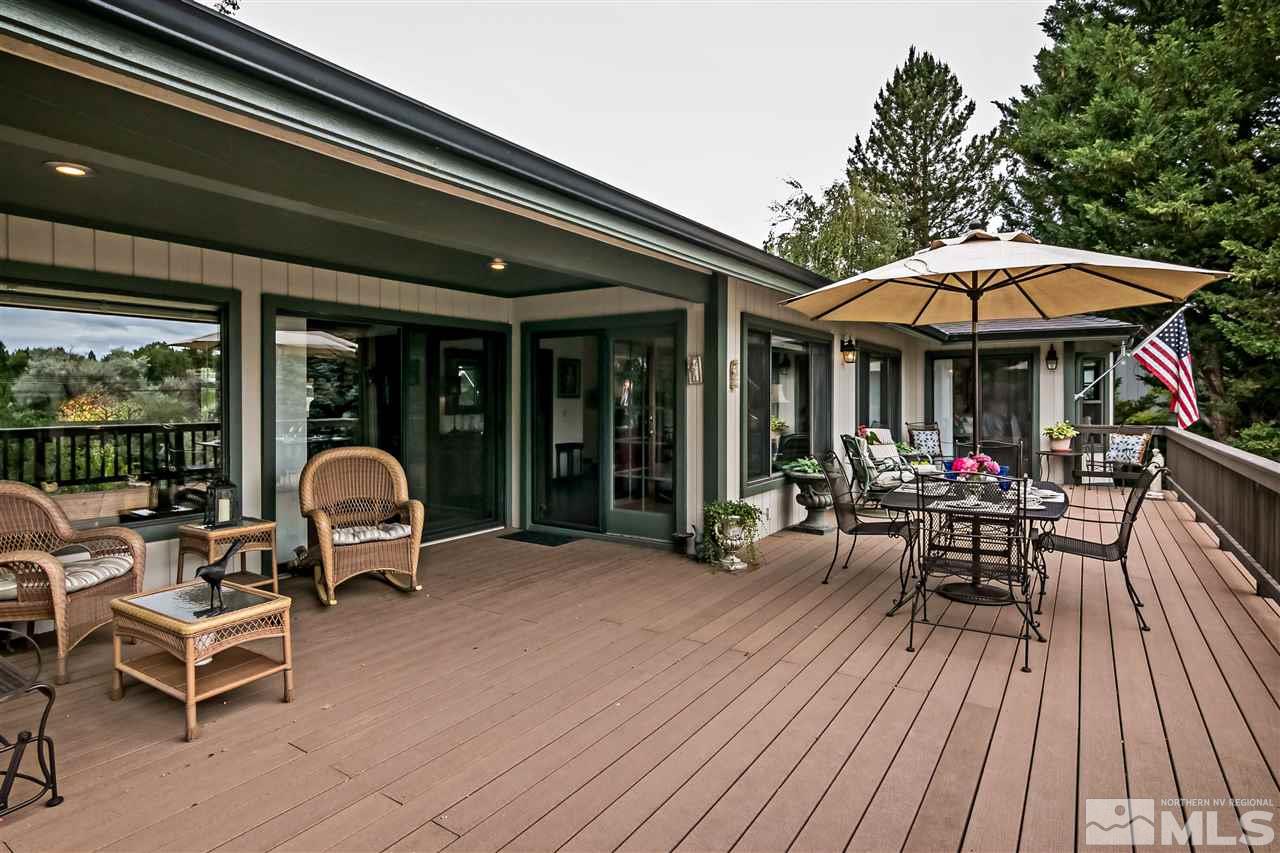 2275 Pennswood Way Reno, NV 89509 - Photo 11 of 33 a view of a patio with table and chairs under an umbrella with wooden floor