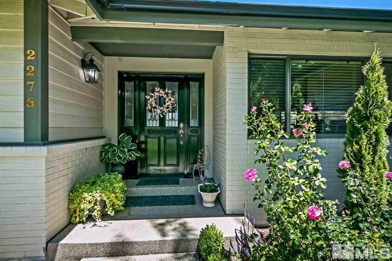 2275 Pennswood Way Reno, NV 89509 - Photo 3 of 33 a potted plant sitting in front of a house