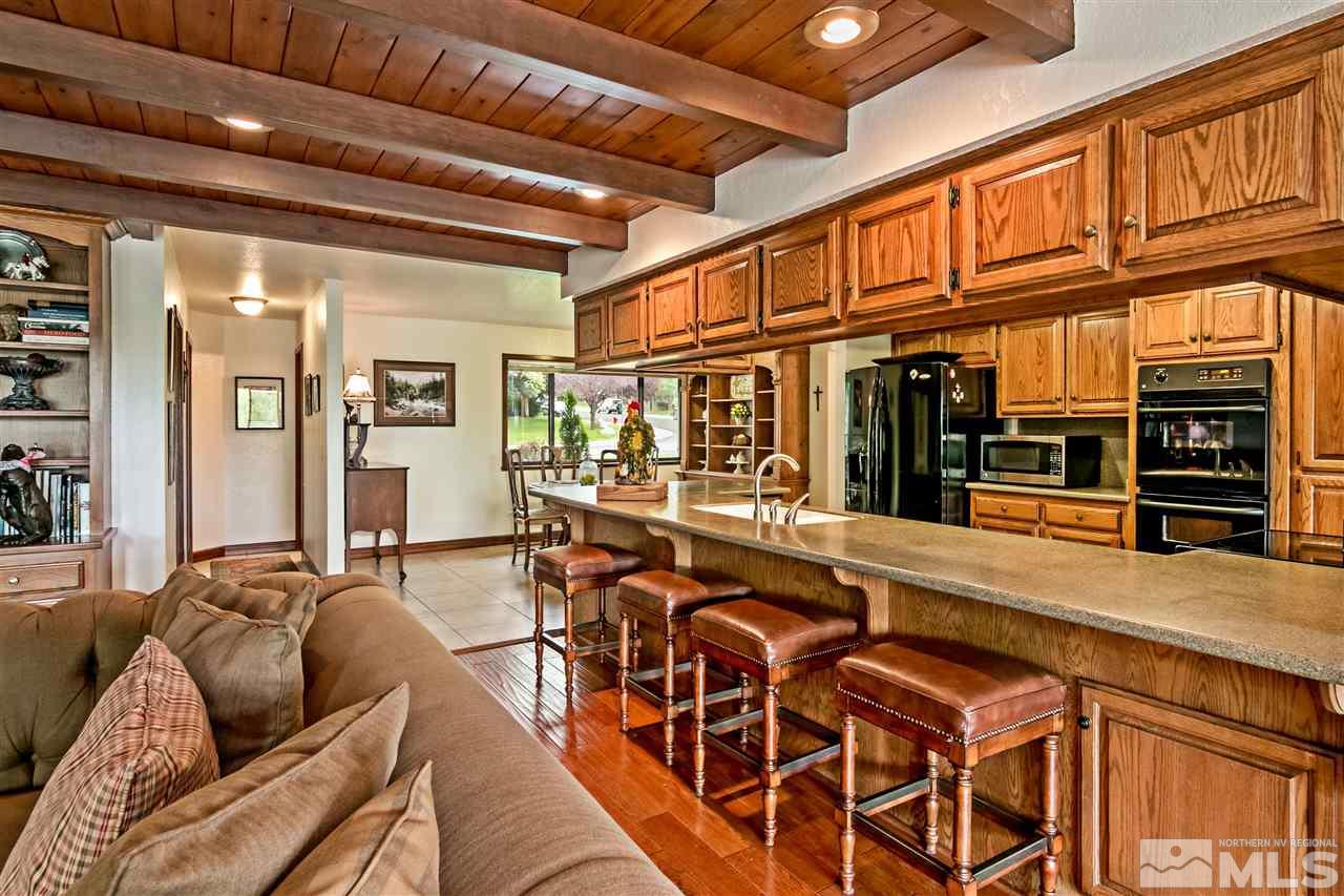 2275 Pennswood Way Reno, NV 89509 - Photo 6 of 33 a living room with furniture a fireplace and wooden floor