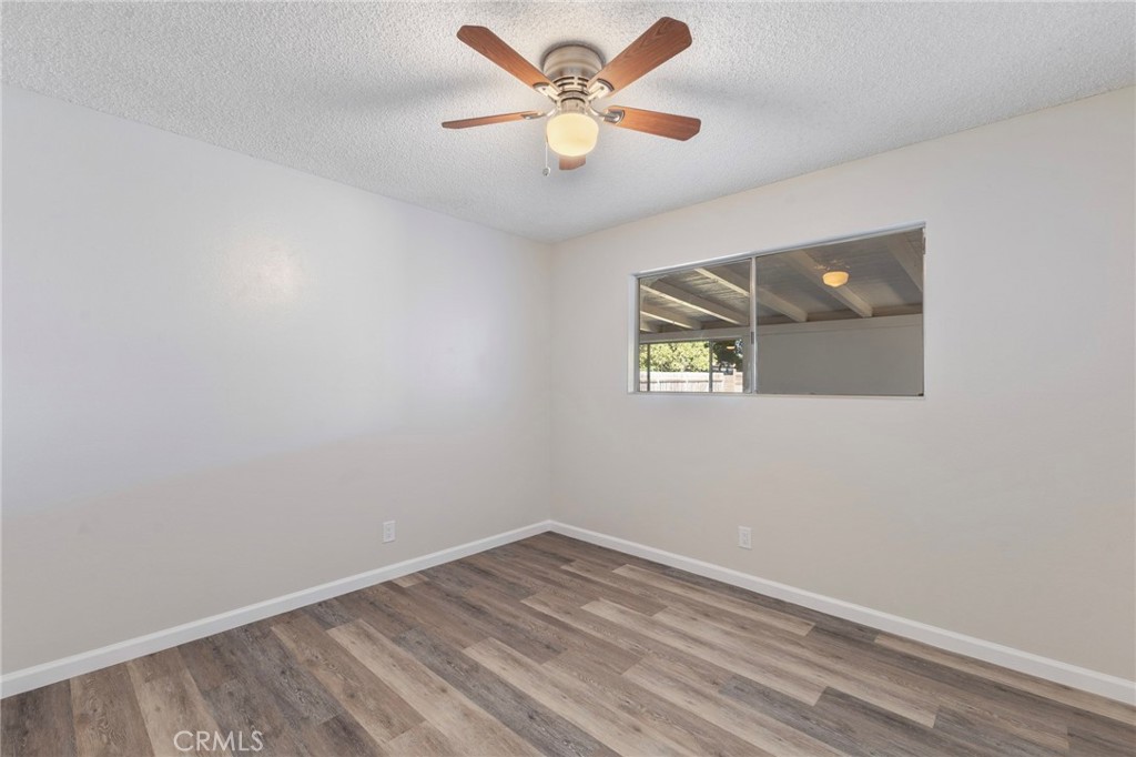 8737 Rhodes Court Santee, CA 92071 - Photo 21 of 30 an empty room with a window and a fan