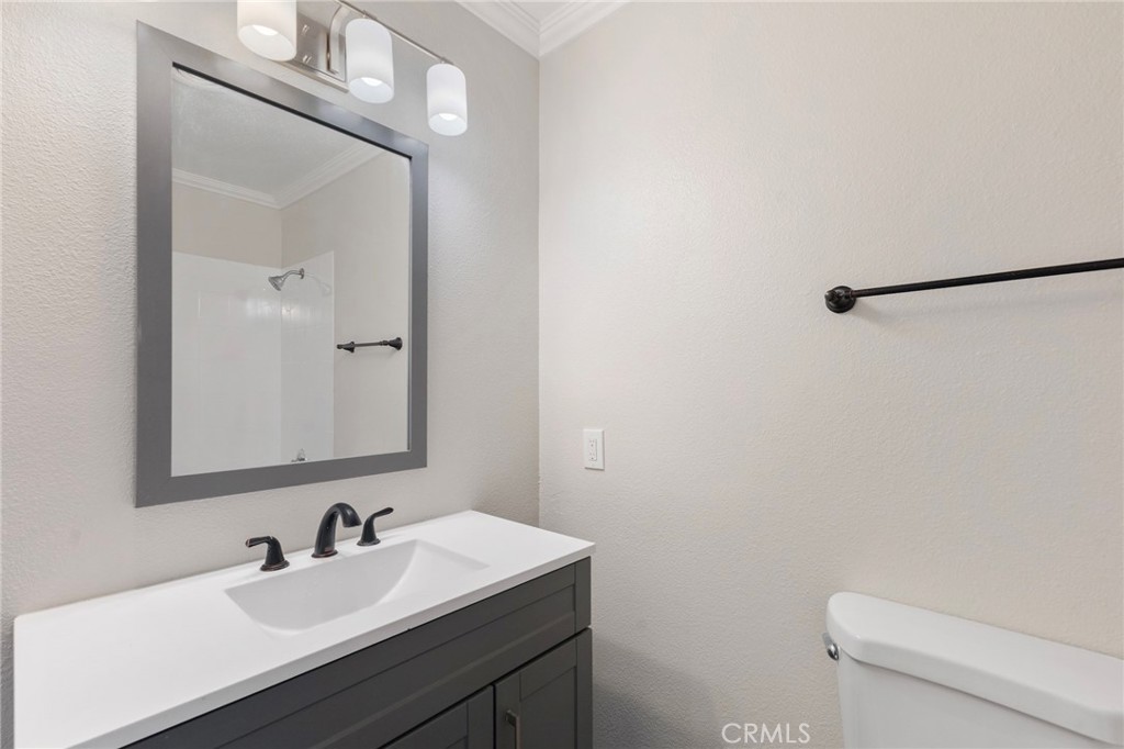 8737 Rhodes Court Santee, CA 92071 - Photo 23 of 30 a bathroom with a toilet a sink and mirror
