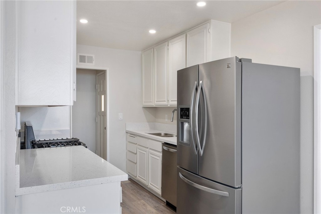 8737 Rhodes Court Santee, CA 92071 - Photo 5 of 30 a kitchen with stainless steel appliances granite countertop a refrigerator and a sink