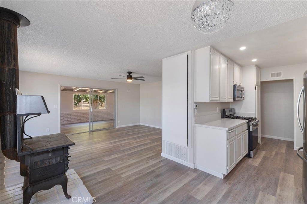 8737 Rhodes Court Santee, CA 92071 - Photo 7 of 30 a kitchen with a refrigerator and a stove top oven