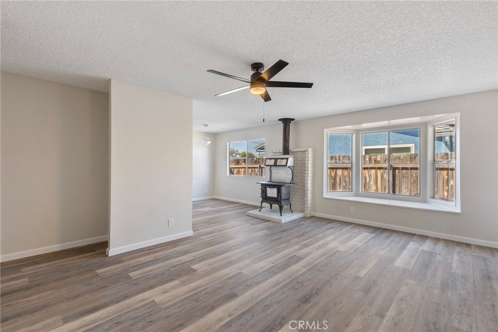 8737 Rhodes Court Santee, CA 92071 - Photo 9 of 30 a view of an empty room with a window and wooden floor
