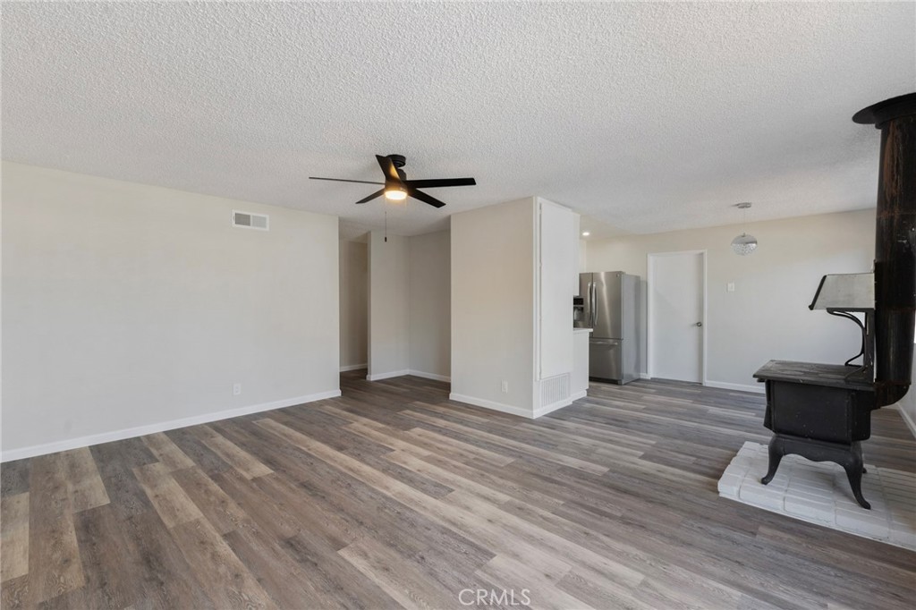 8737 Rhodes Court Santee, CA 92071 - Photo 10 of 30 a view of empty room with wooden floor and fan