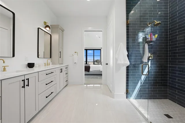 a bathroom with double vanity sink and a mirror