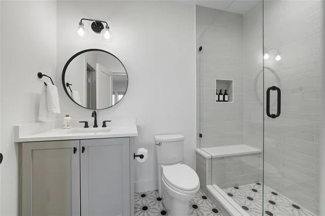 a bathroom with a sink toilet and shower