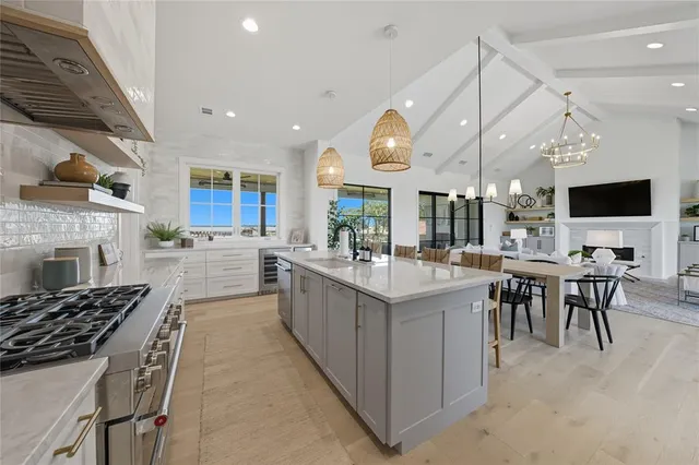 a kitchen with counter space appliances and a living room view