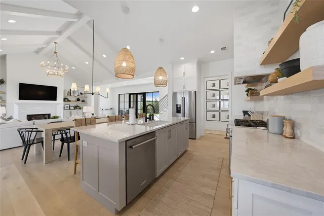 a large kitchen with a table and chairs