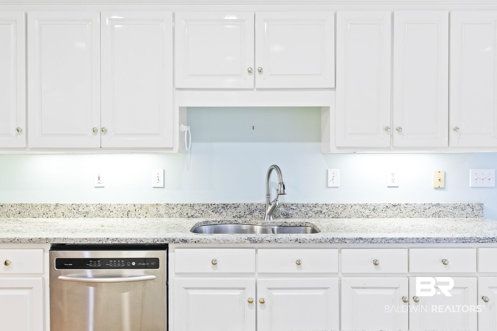 2100 Stonebrook Drive West Mobile, AL 36695 - Photo 20 of 60 Kitchen with stainless steel dishwasher, light stone counters, white cabinetry, and sink